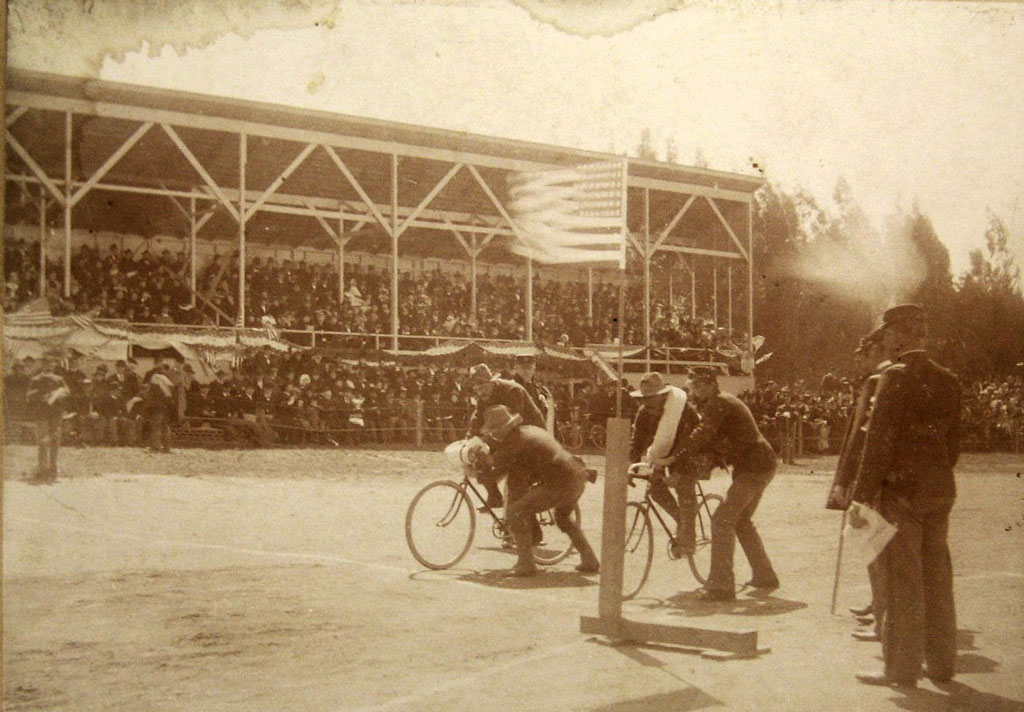 Bicyclists preparing to race in front of audience