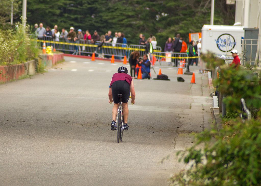 Bicyclist riding through Fort Scott in triathlon.