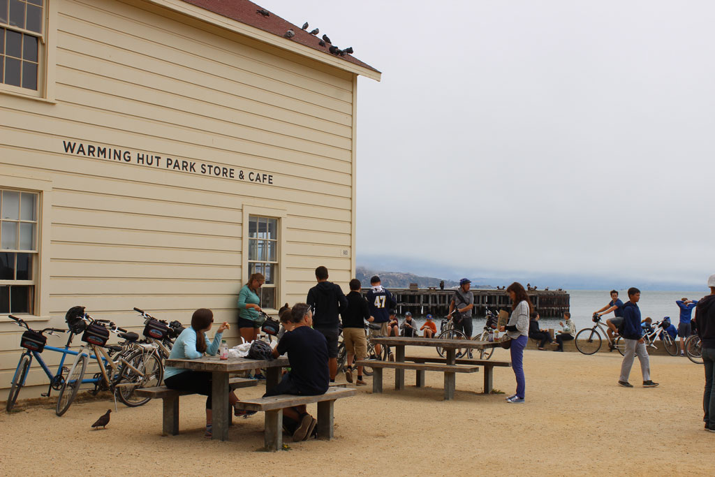 Visitors at picnic tables next to Warming Hut
