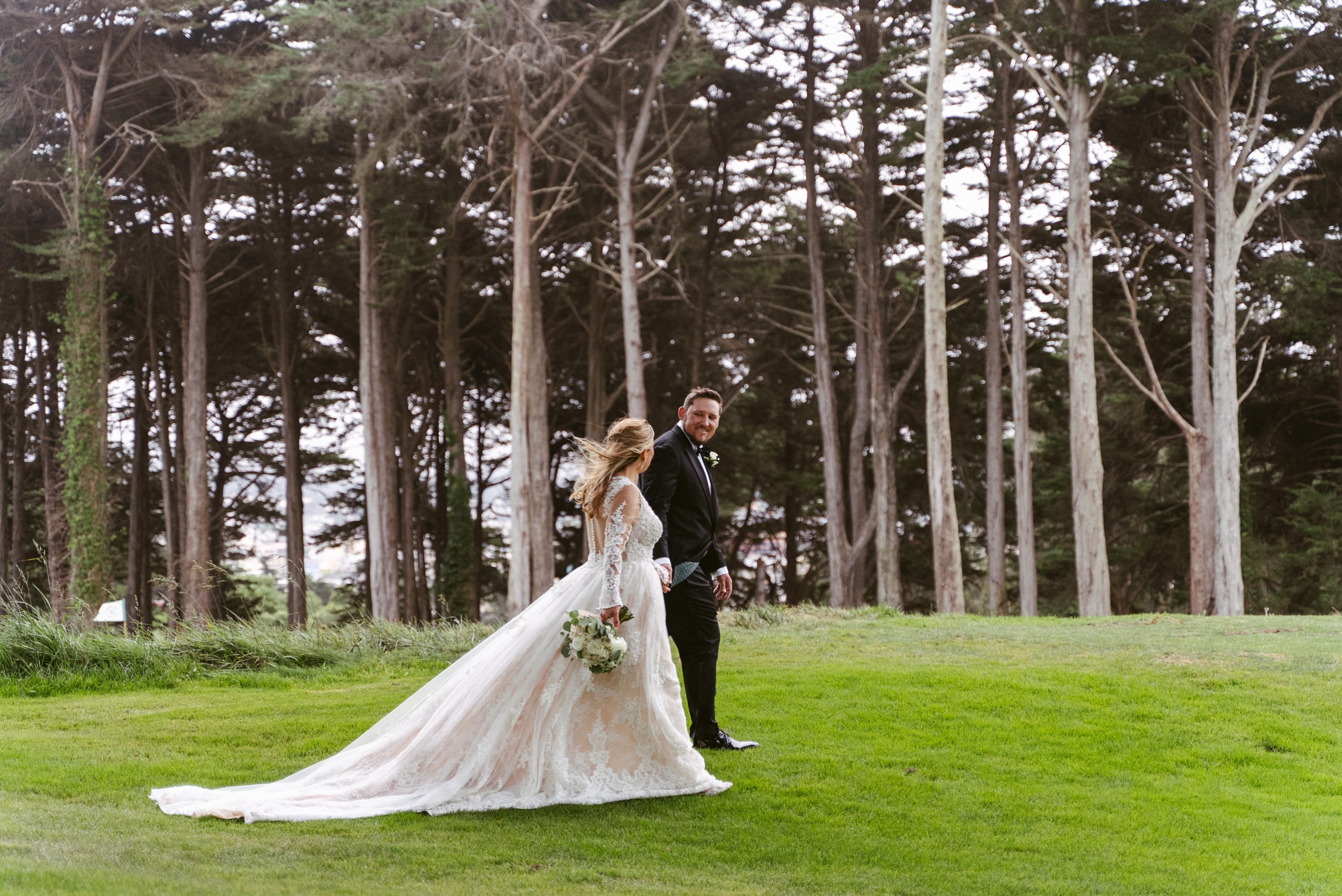 Bride and groom walking together at the Presidio Golf Course