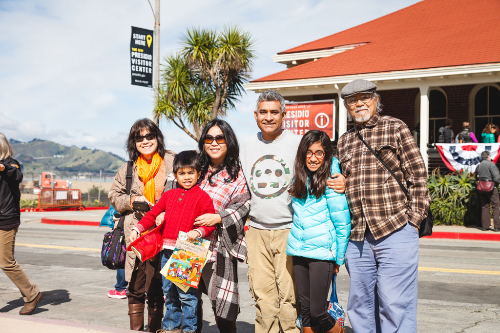 Group photo of adults and children in front of Presidio Visitor Center