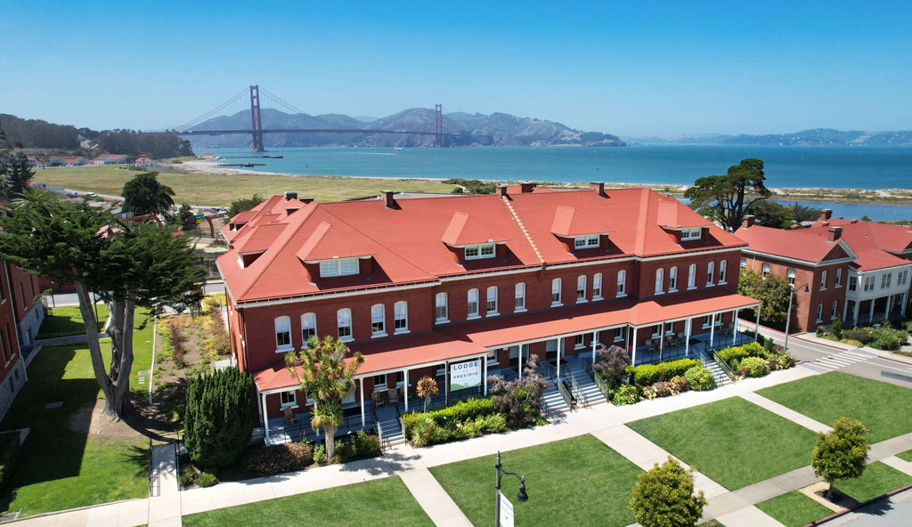 Present day aerial view of Montgomery Street barrack as Lodge at the Presidio with Golden Gate Bridge in background