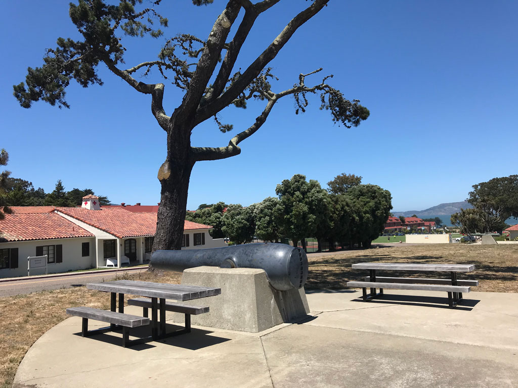 Picnic tables next to cannon at Pershing Square in Main Post