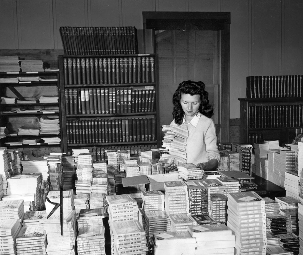 Woman with stacks of books