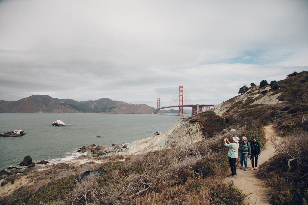 Visitors photographing the bay at Batteries to Bluffs trail