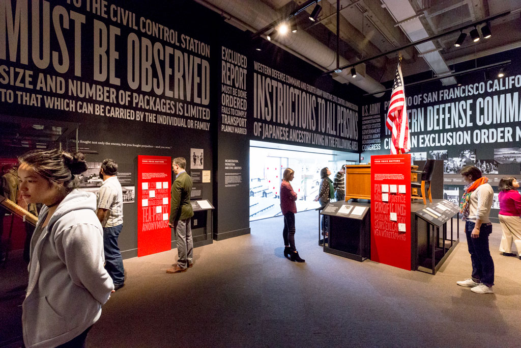 Visitors viewing the Exclusion exhibit