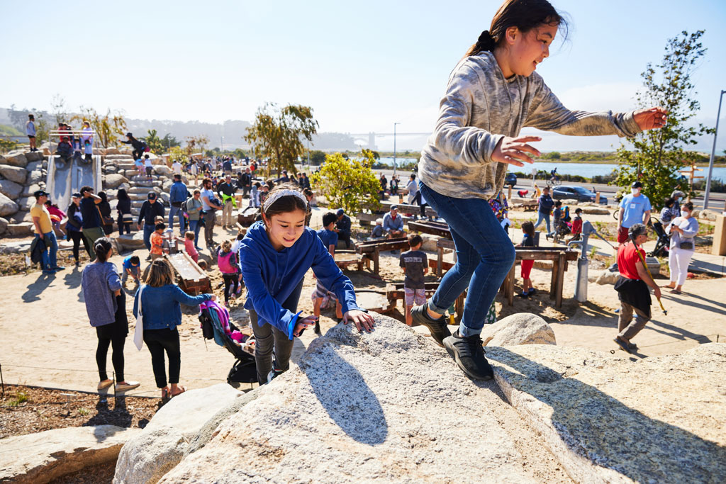 Kids and families playing and utilizing Outpost play space