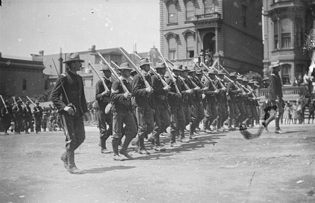 Presidio soldiers marching in a parade down Van Ness Avenue