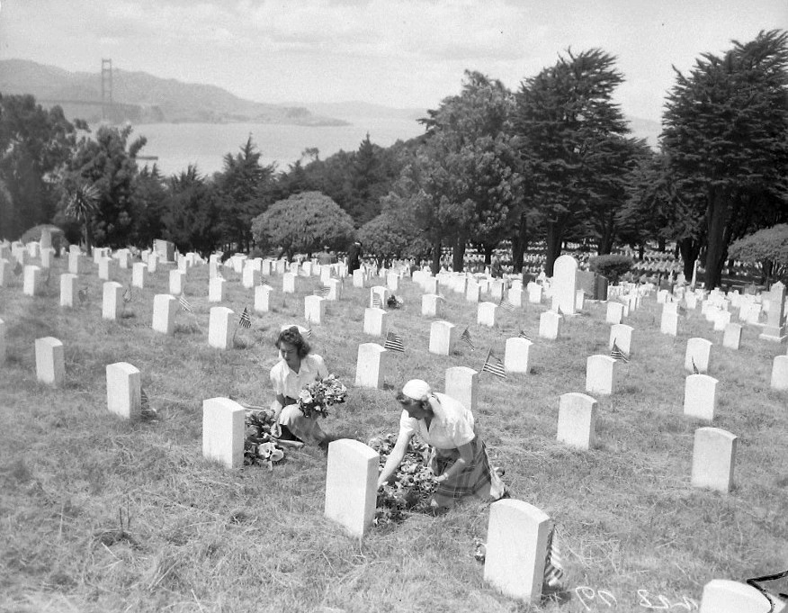 A couple women decorating graves in San Francisco National Cemetery