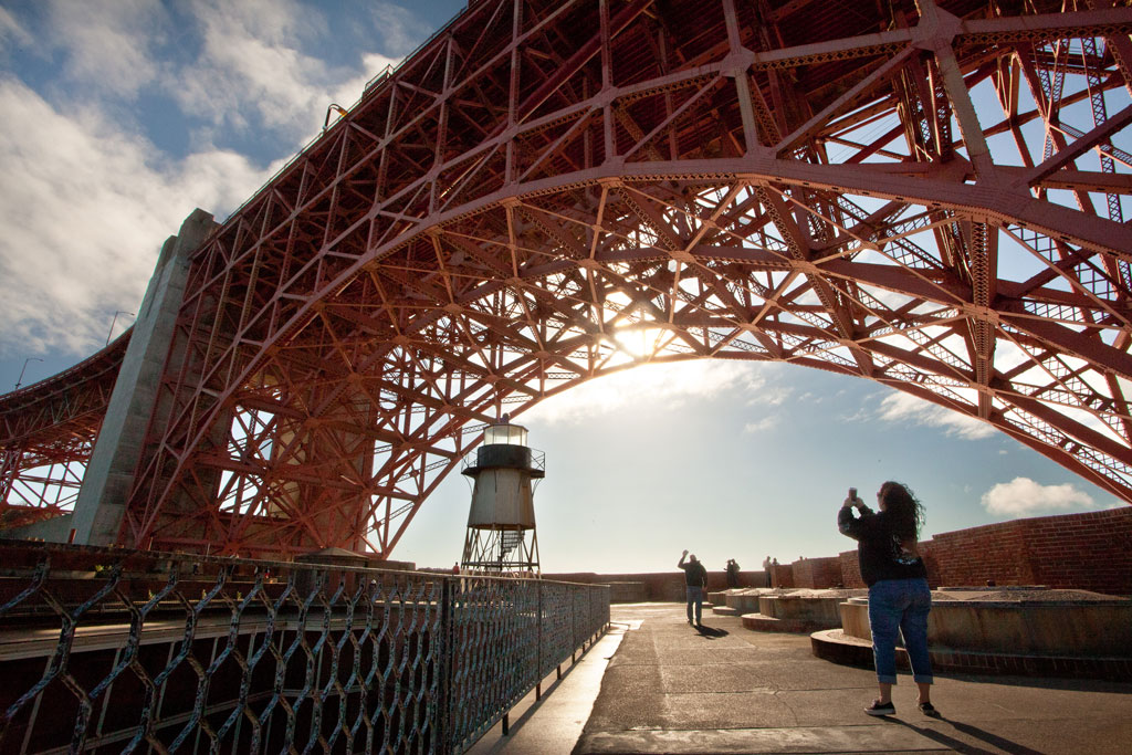 Woman taking a photo underneath Fort Point