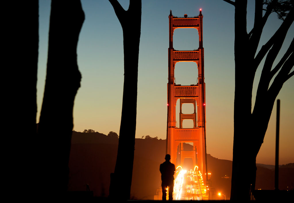 Man standing at overlook of Golden Gate Bridge view at night