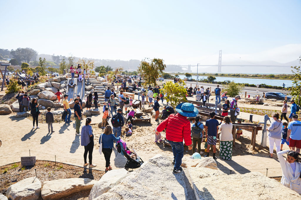 Children and adults utilizing Outpost Playground