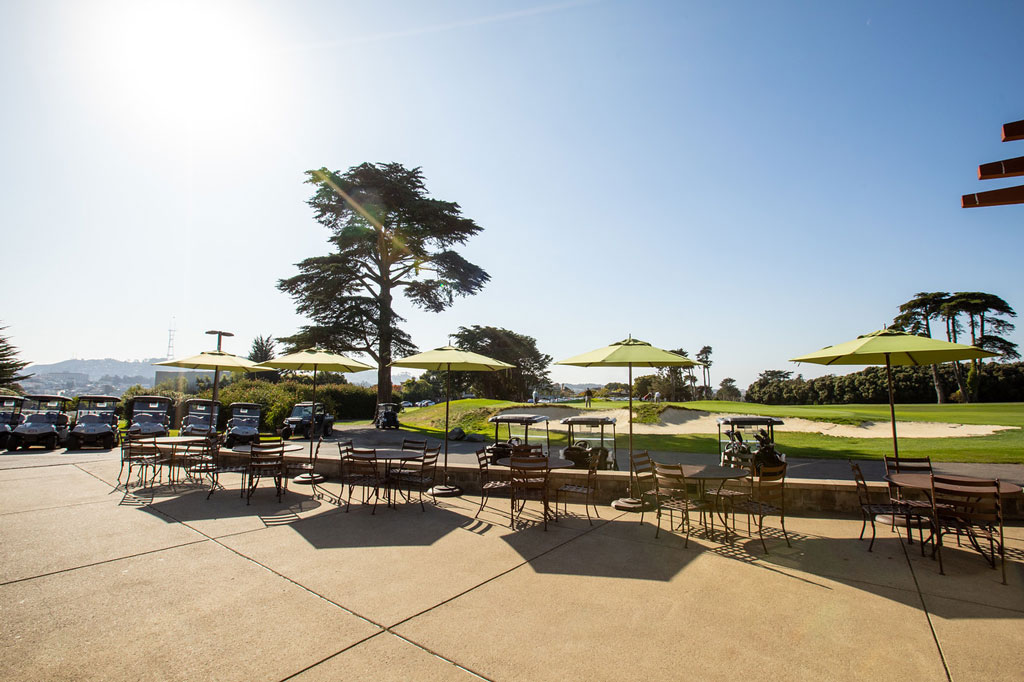 Outdoor dining tables and umbrellas at Presidio Golf Course