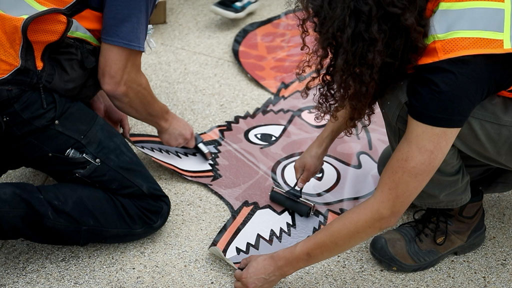 Coyote art being applied to ground