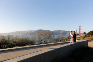 Woman taking a photo of the Golden Gate Bridge at Pacific Overlook.