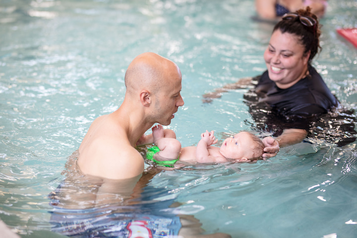 Two teachers with an infant in the pool at La Petite Baleen Swim School in the Presidio. Photo courtesy of La Petite Baleen.