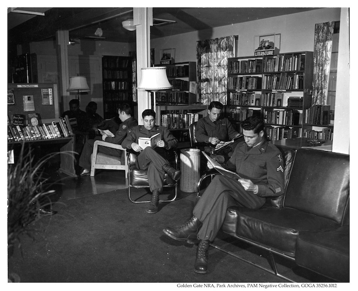 Men sitting in a library reading books and magazines