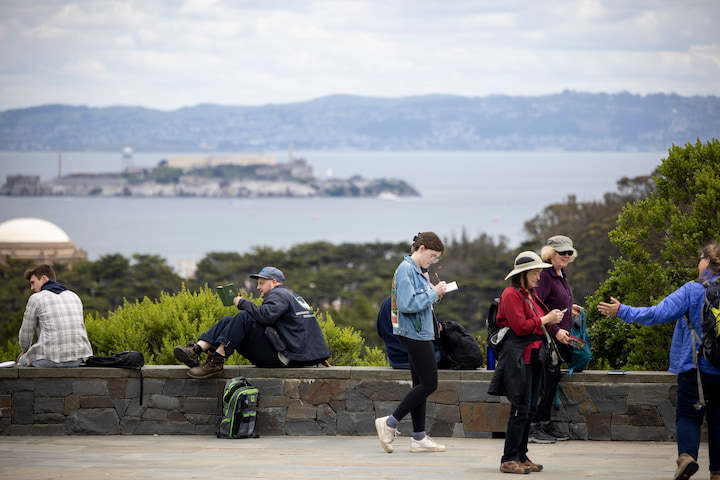 Several people enjoying the view from the plaza at Inspiration Point.