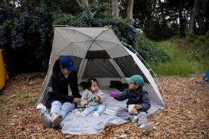 A woman and two children camping at Rob Hill.