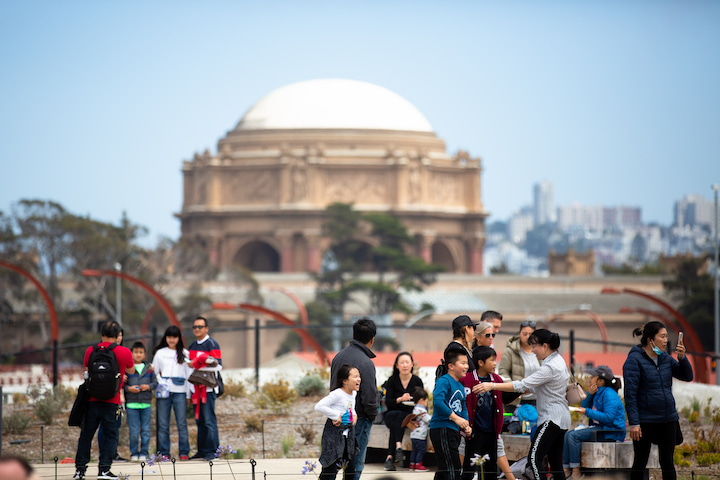 A crowd gathers at Presidio Tunnel Tops on opening day, with the Palace of Fine Arts in the background.