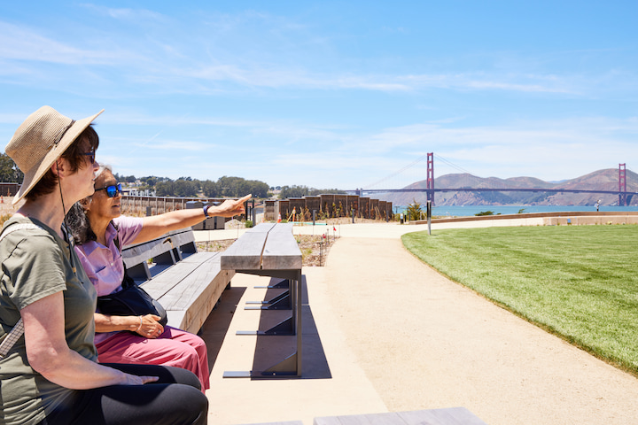 Two women sitting on a bench at Golden Gate Meadow.