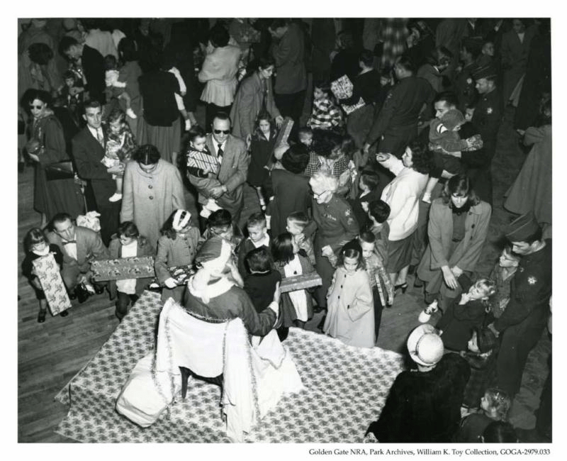 Black and white image of Santa Clause facing group of children in 1952.