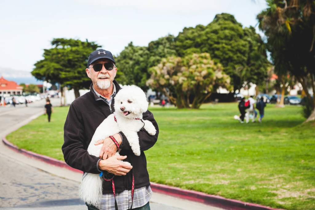 Paul Van Slambrouck with his white fluffy dog.