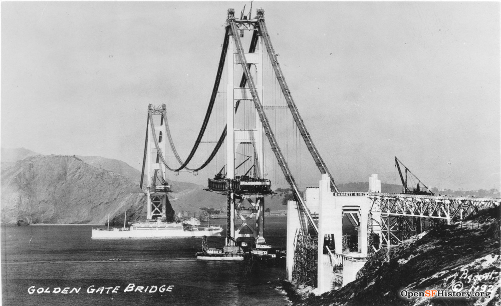 Black and white image of Golden Gate Bridge during construction with the towers up but not the road.