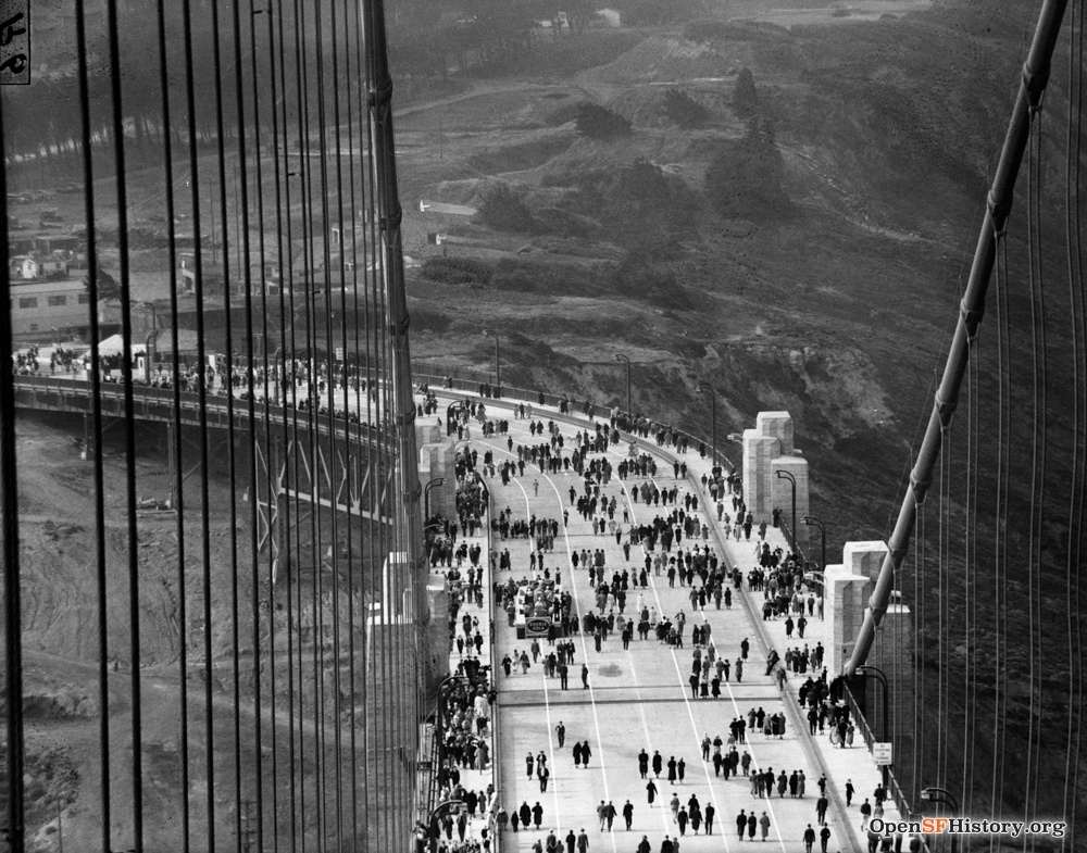 Black and white image of people walking the Golden Gate Bridge when it was open to the public.