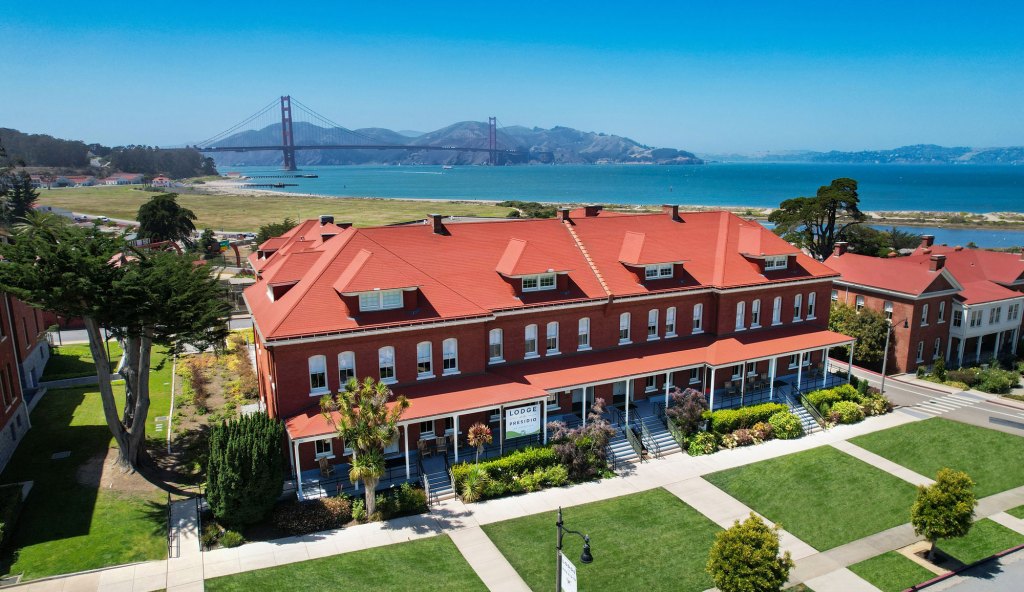 Exterior view of the Lodge at the Presidio with Golden Gate Bridge in the background