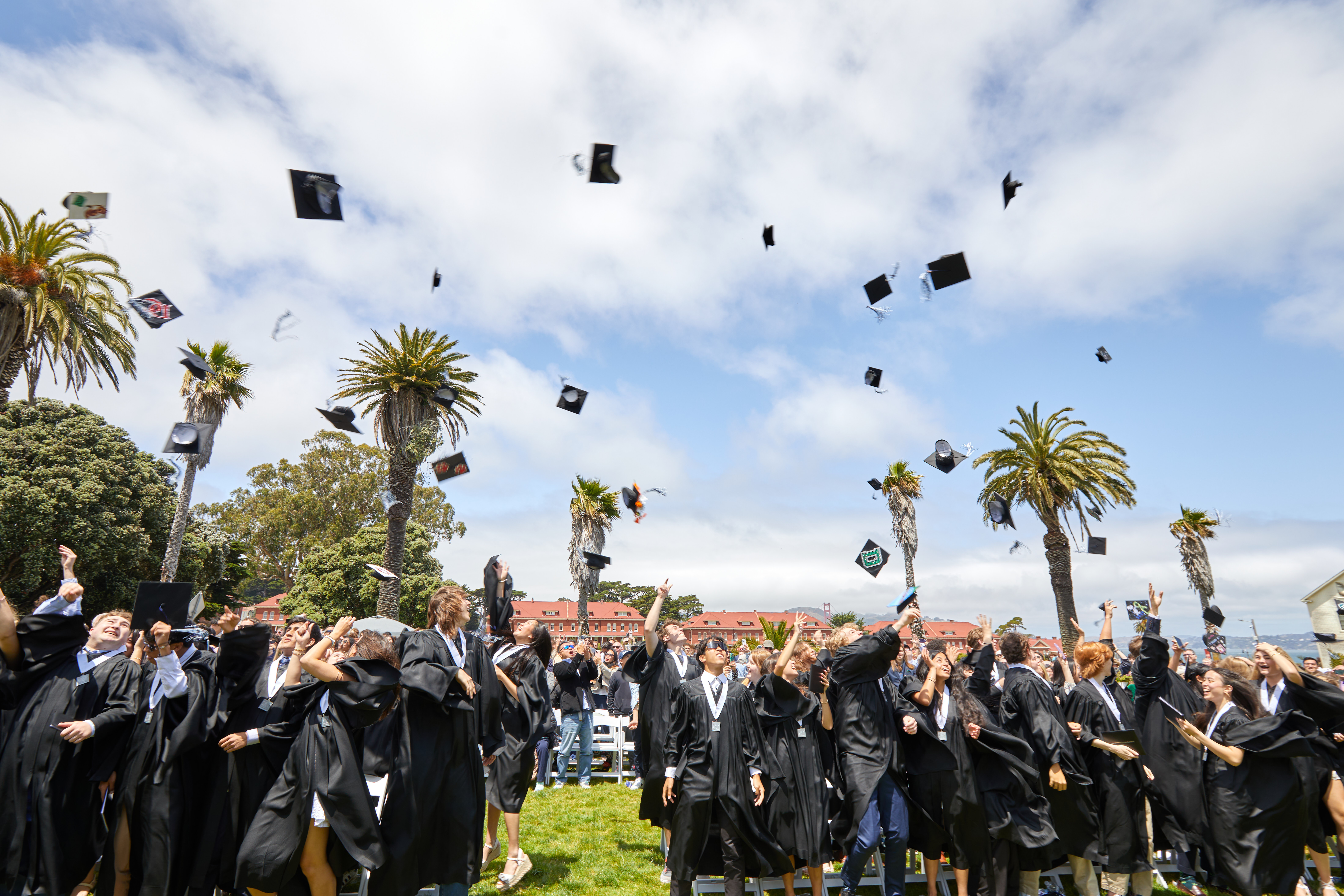 graduating students tossing caps from Bay School