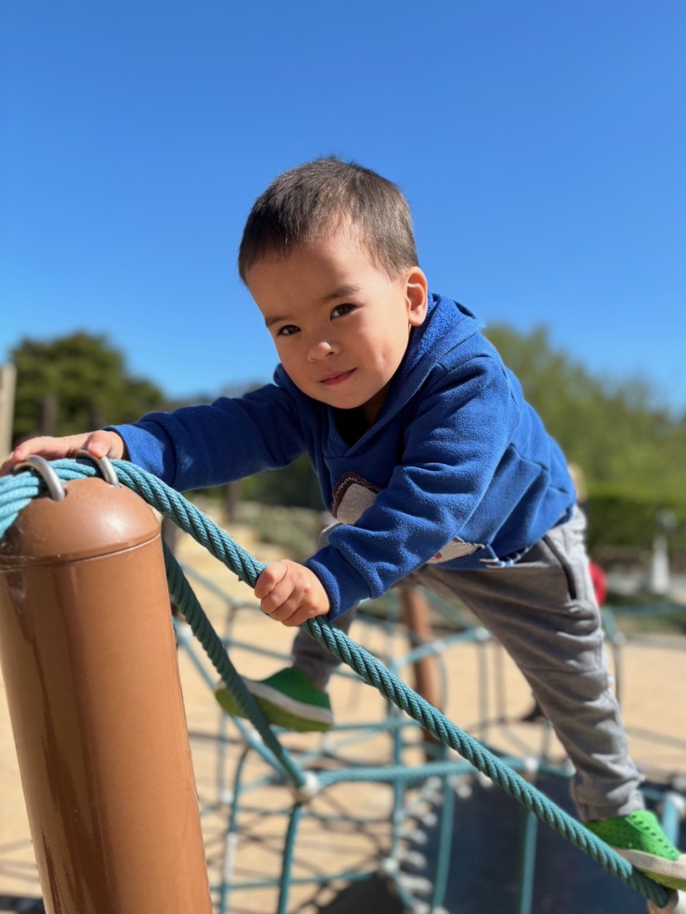 Playgroup boy climbing