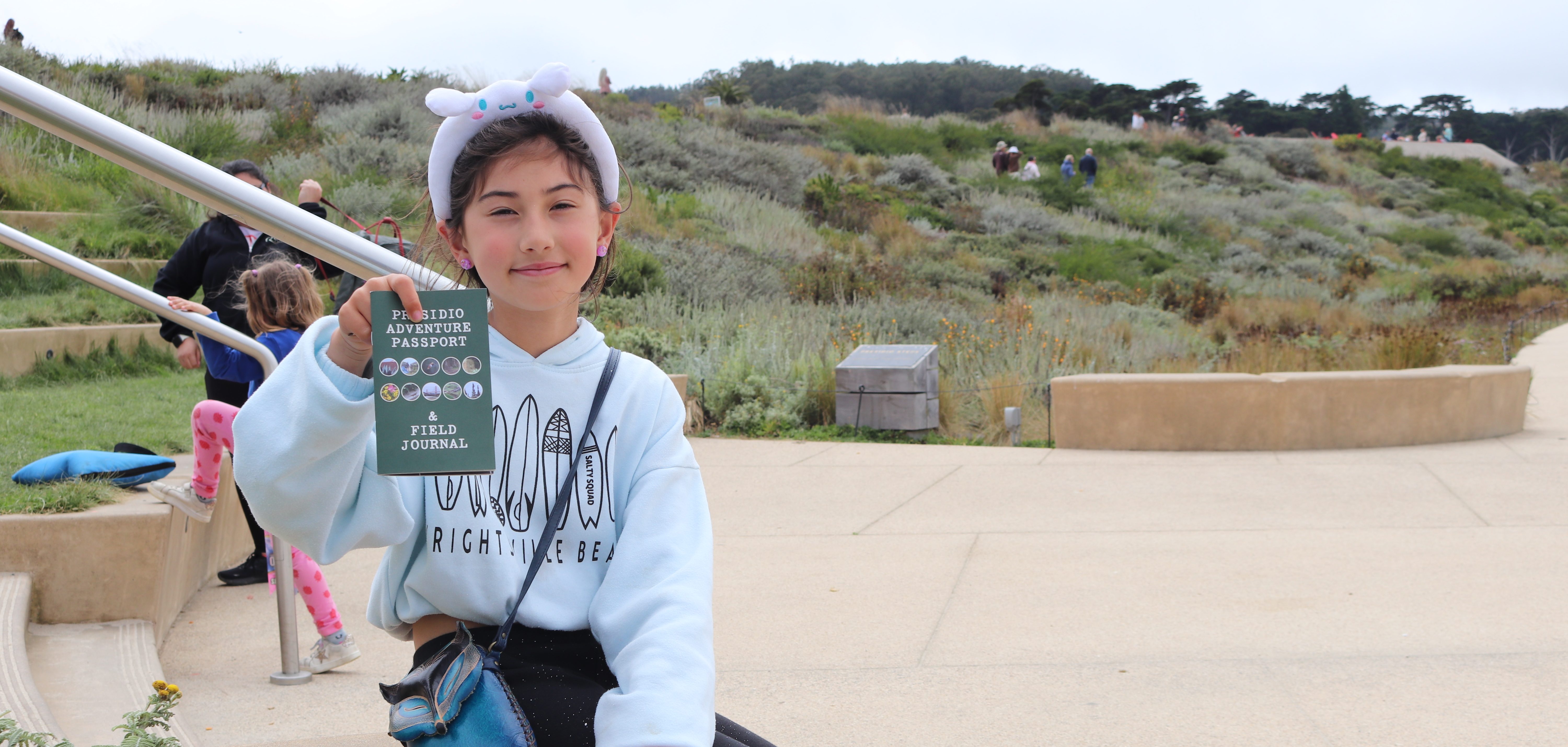 Young girl holding Presidio Passport