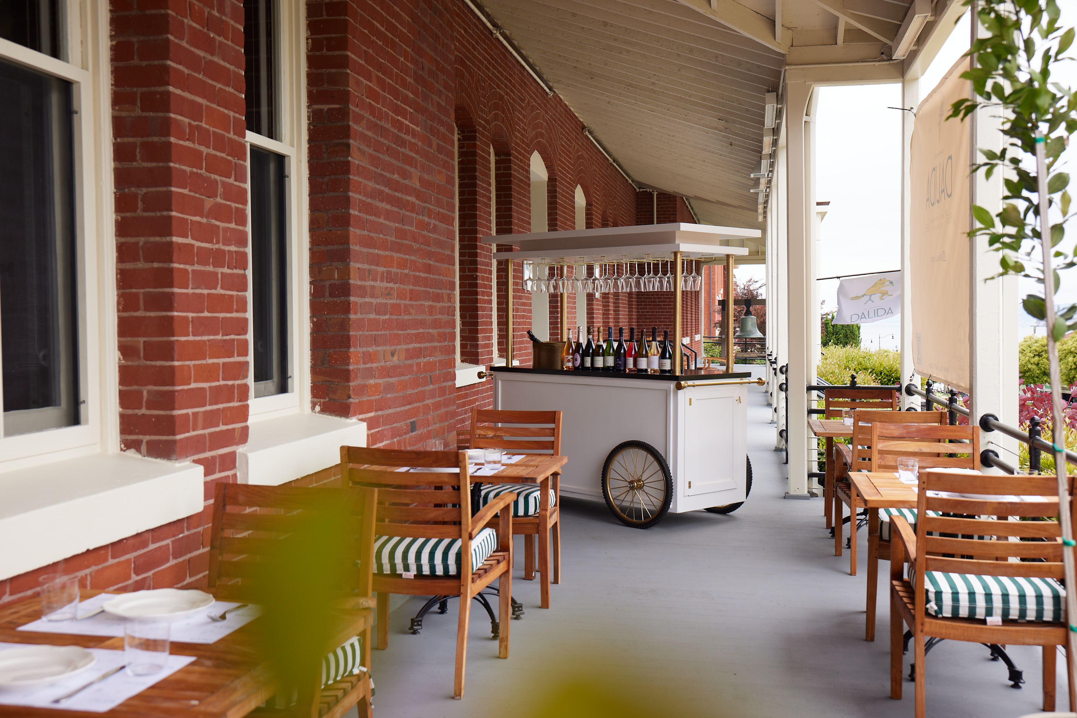 Dalida outdoor patio with tables and a bar cart set up