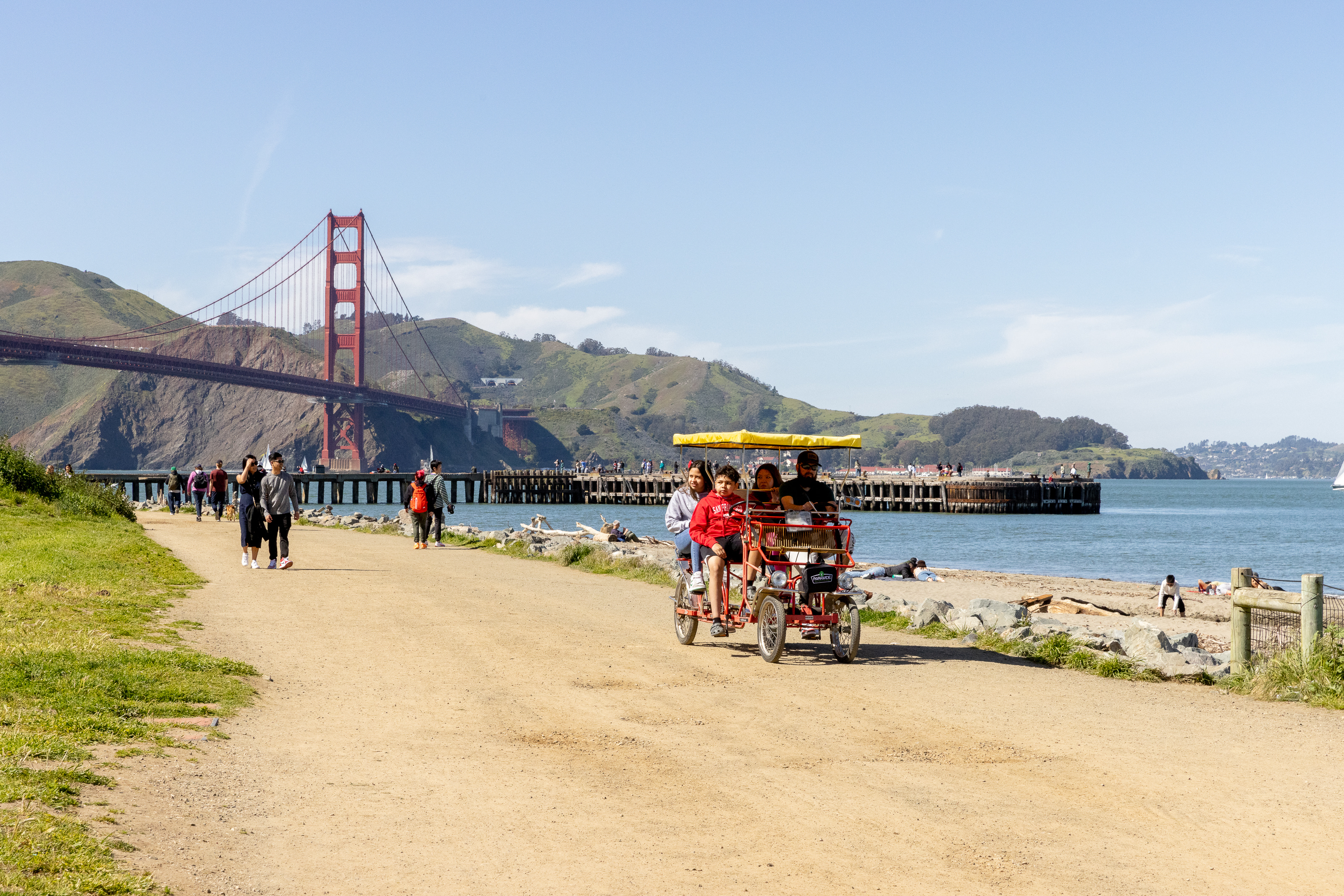 Bikes riding along the Golden Gate promenade with the Golden Gate Bridge in the background