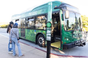 Photo of the Presidio GO Shuttle with people waiting to board.